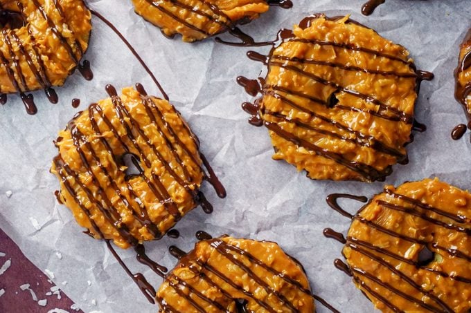 drizzled chocolate on cookies laid out on a sheet of wax paper