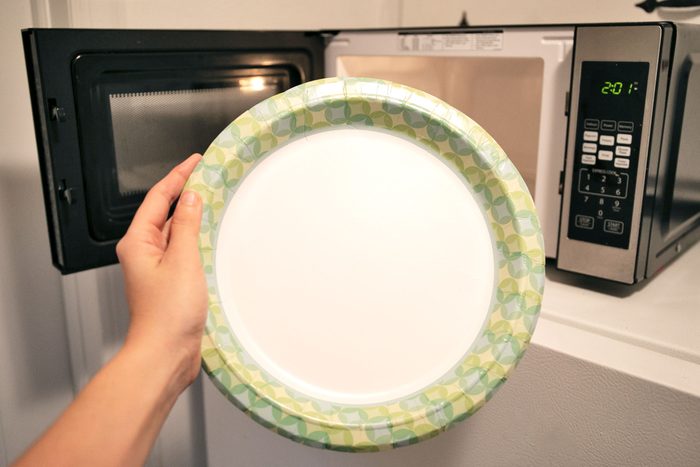 paper plate in front of microwave
