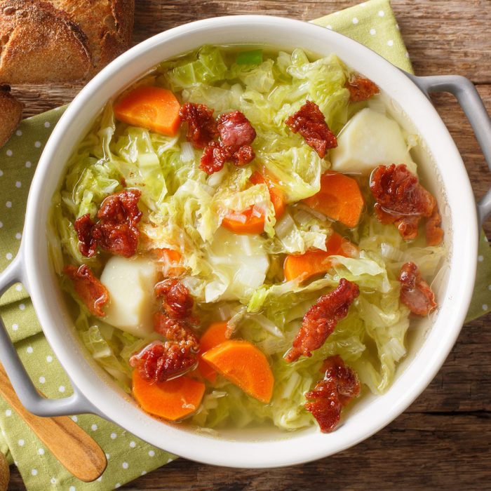 Autumn vegetable soup with fried bacon closeup in a bowl. Horizontal top view