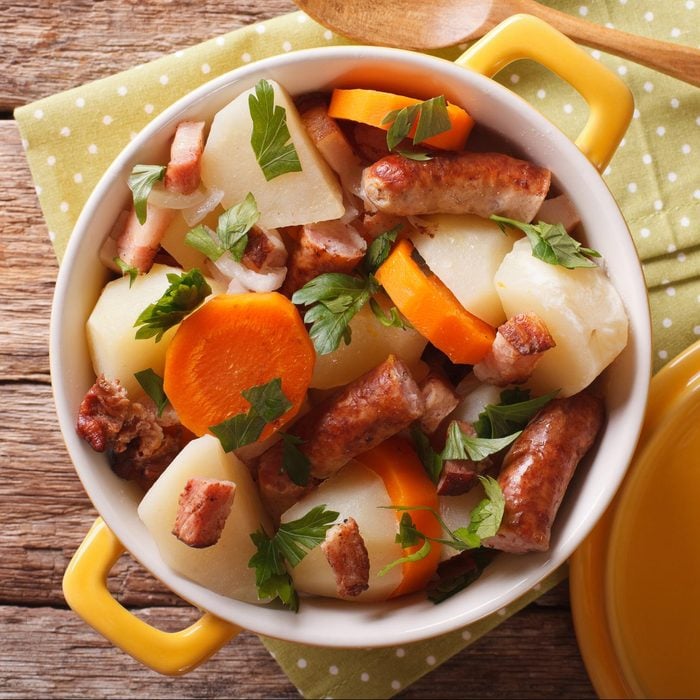 tasty Irish coddle with pork sausages, bacon and vegetables