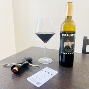 Wine Subscription with wine glass and bottle on table