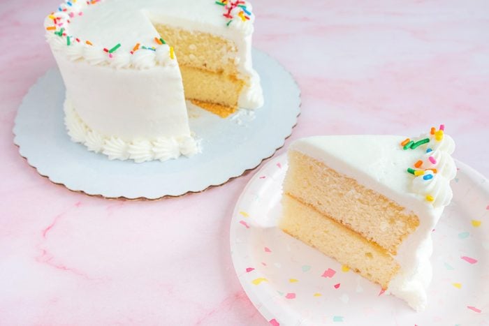 cake from walmart with a slice from it next to the whole cake on pink background