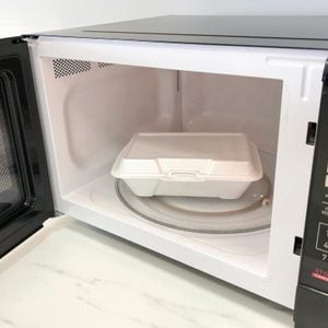 Styrofoam food packaging inside an open microwave