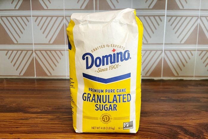 Domino bag of white sugar on a wooded countertop in a kitchen