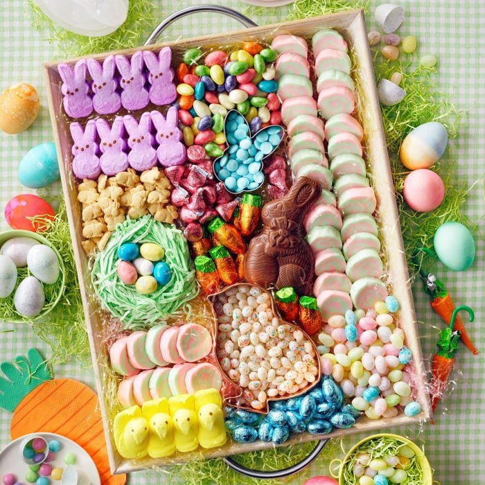 Festive Charcuterie Board made with Easter Candy on a green checkered table cloth