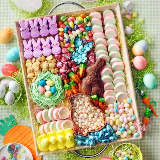 Festive Charcuterie Board made with Easter Candy on a green checkered table cloth