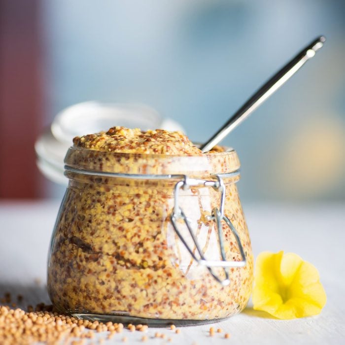 Wholegrain mustard in a jar on a table