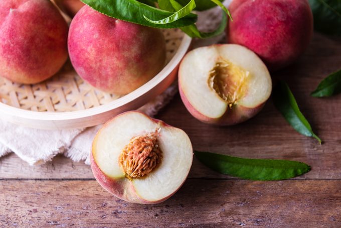 Fresh sweet peaches on the wooden table