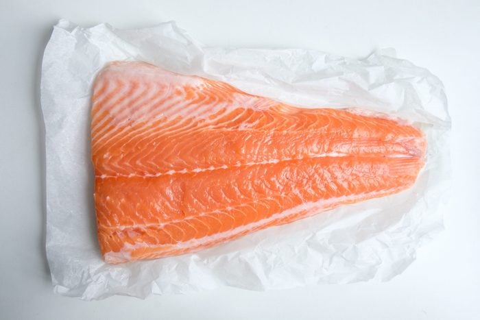 Fillet of salmon fish on white paper closeup
