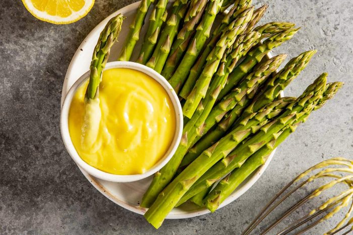 bowl of asparagus with smaller bowl of aioli