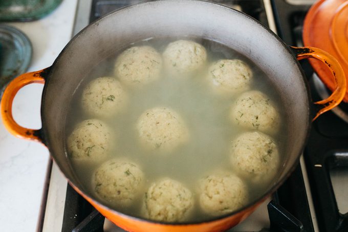 matzo balls in a pot of water on a stove