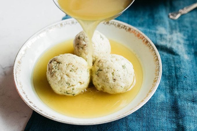 Serving matzo in a bowl with chicken soup broth
