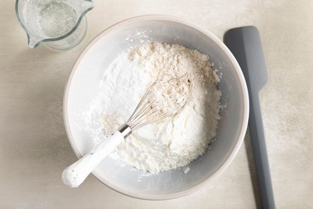 flour in a bowl with a whisk