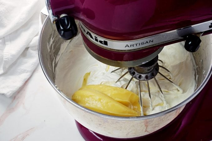 View of a kitchen aid mixer combining two different ingredients for a desert recipe, view from above