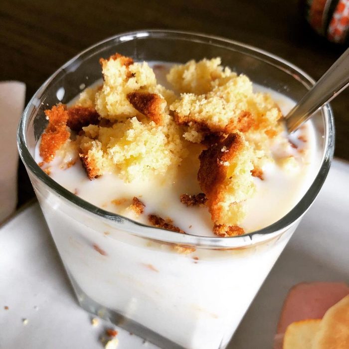 Cornbread And Milk in a glass with a spoon