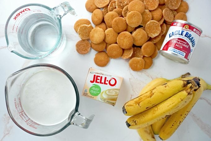 Ingredients for Magnolia Banana Pudding flat lay on a white marble kitchen counter top