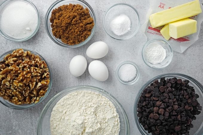 ingredients for making cookies on a counter in various glass bowls