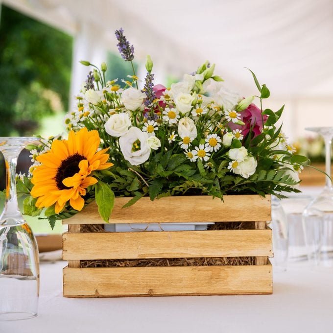 floral arrangement in wooden box vase