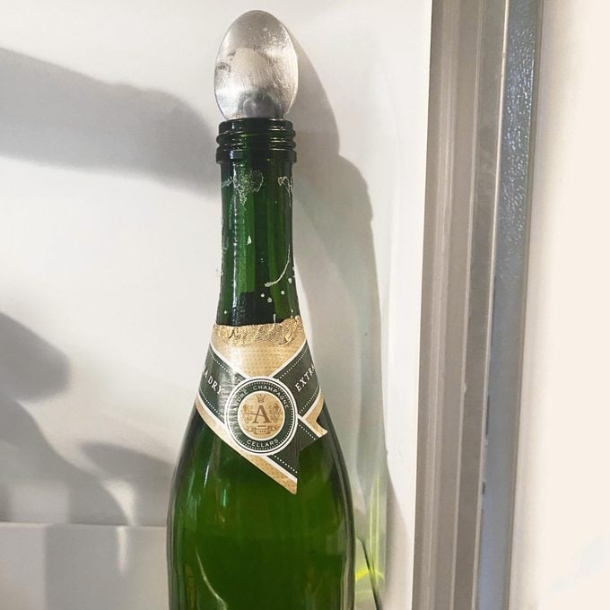 spoon in champagne bottle in refrigerator