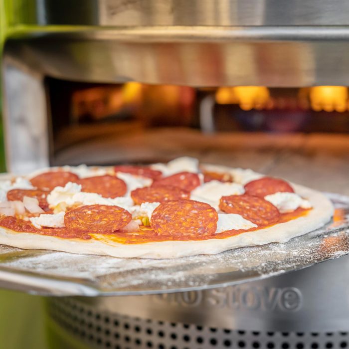 raw pizza going into solo stove