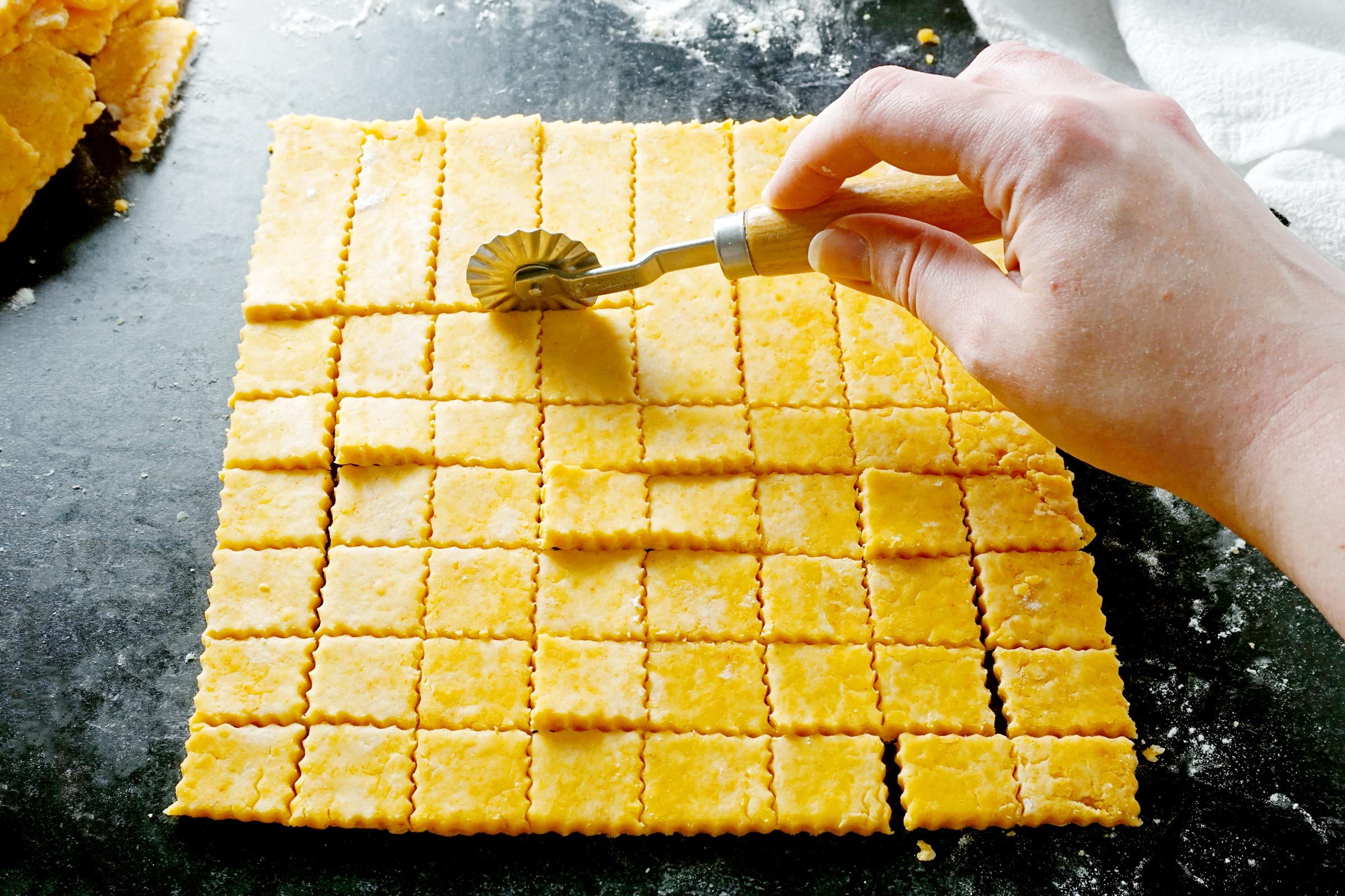 Cutting Squares with a pastry wheel for Homemade Cheez Its