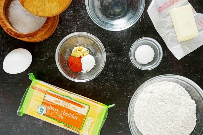 Ingredients for Homemade Cheez Its in glass bowls on a counter