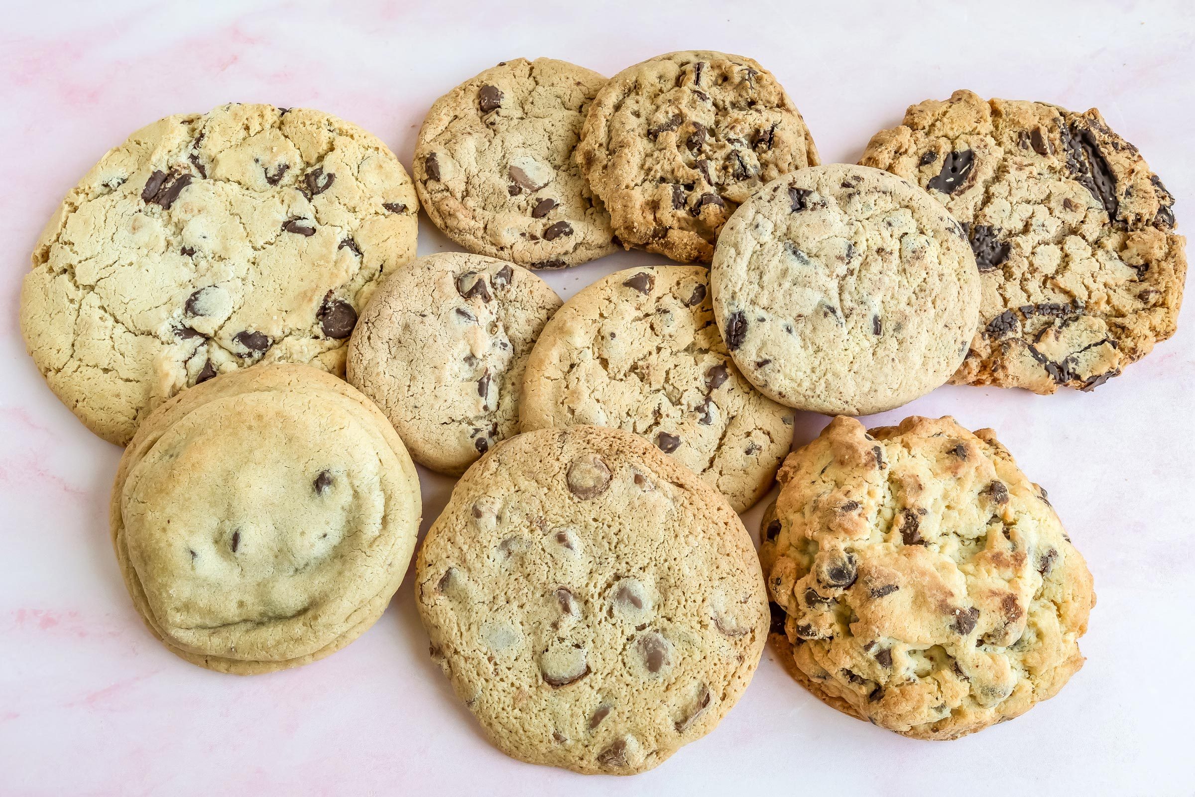 multiple Chocolate Chip Cookies in a pile on a kitchen countertop