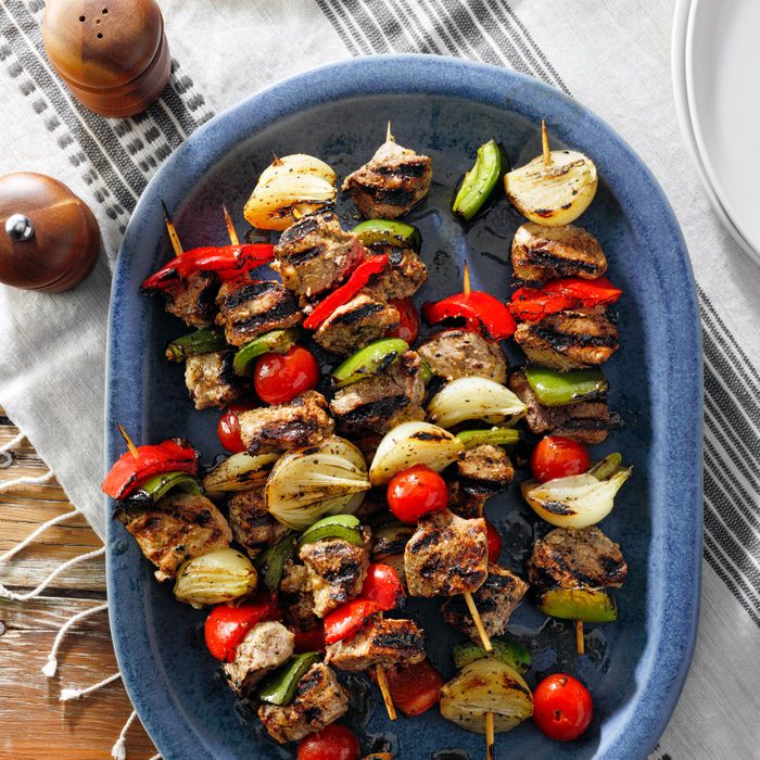 grilled kabobs in a blue serving dish