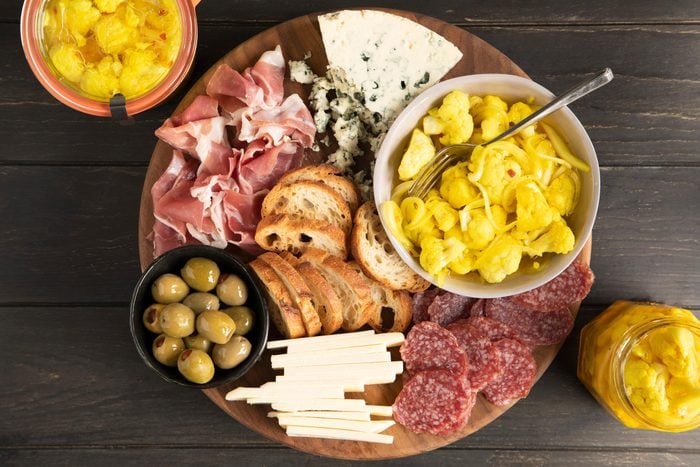 charcuterie board with a bowl of pickled cauliflower
