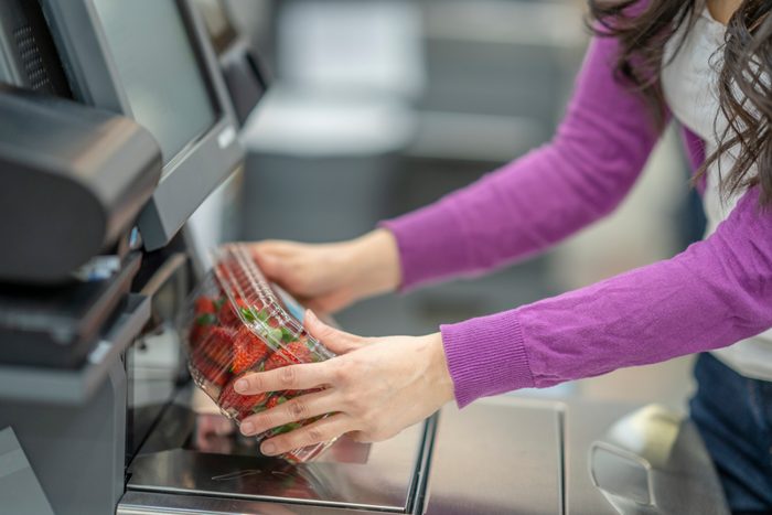 Concept Photo of a Woman Scanning Strawberries at the Grocery Store Self Checkout Service