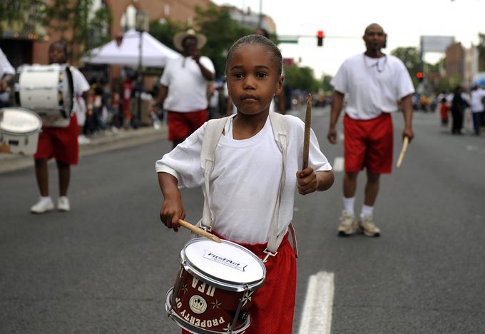 Gabriel Buckmon, 5, plays with the Syrian Temple 49 Youth Drum & Flag Corps during the Juneteenth Parade, in the historic Five Points neighborhood, in Denver, CO. The parade kicked off a daylong festival and celebration. Juneteenth is the oldest nationall