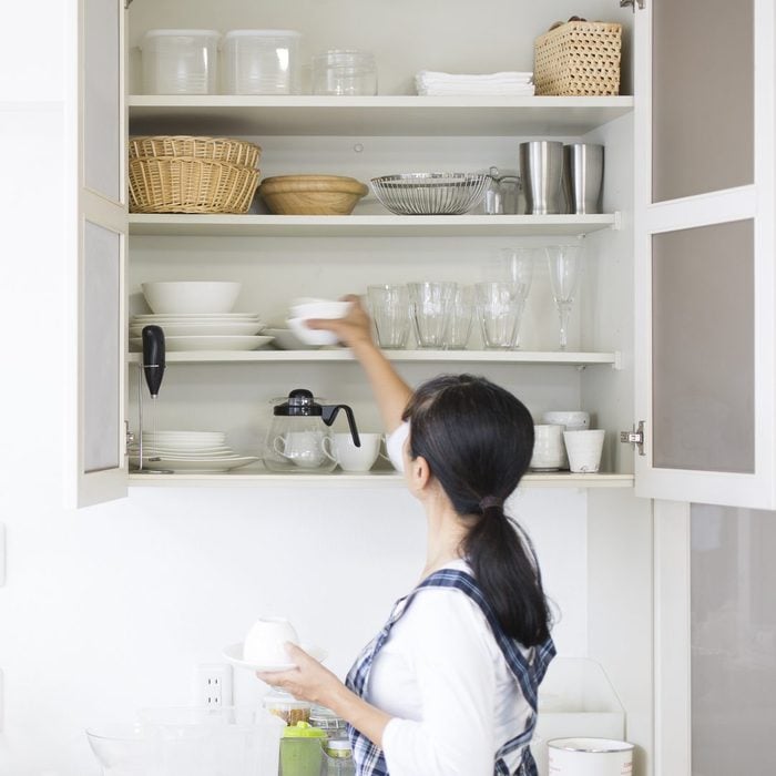 woman organizing Kitchen cabinets