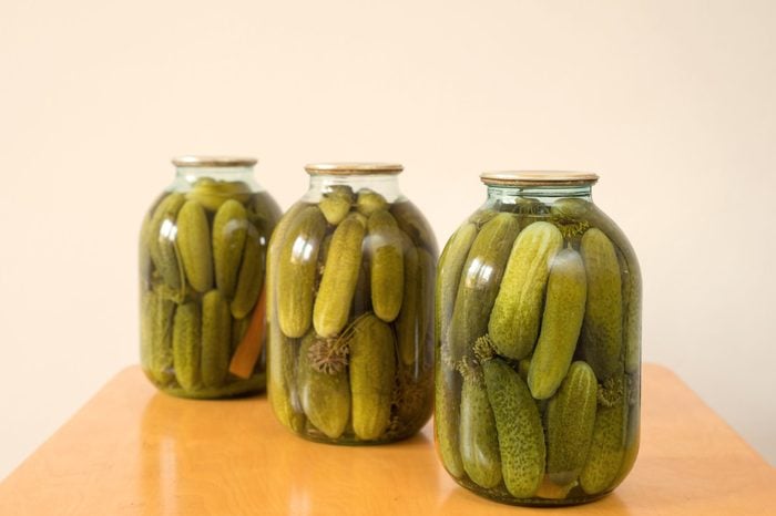 Fresh pickled cucumbers on white background