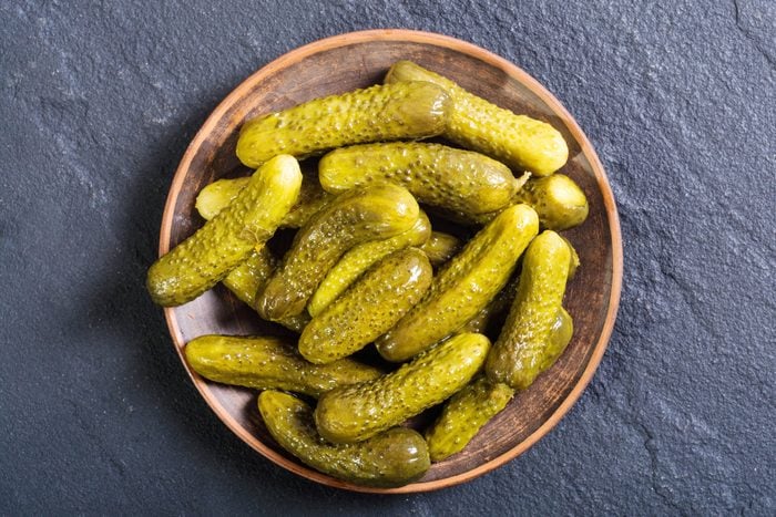 pickles on a plate on a black stone background