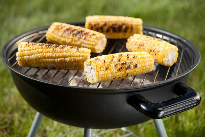 Fresh corn on the cob on a charcoal grill