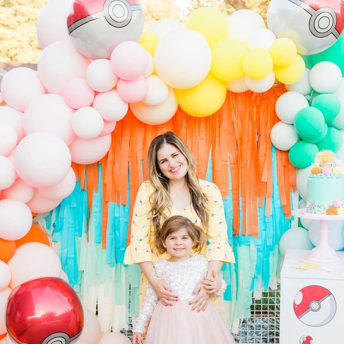 mom and daughter under Balloon Garland themed for a Pokemon Birthday