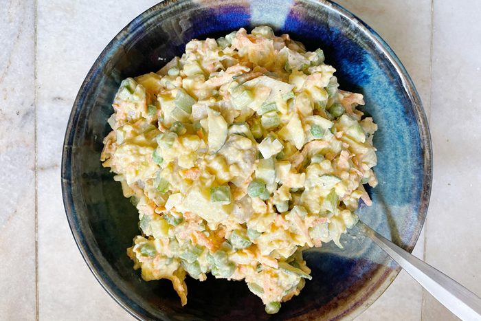 finished Hawaiian potato salad in a blue ceramic bowl