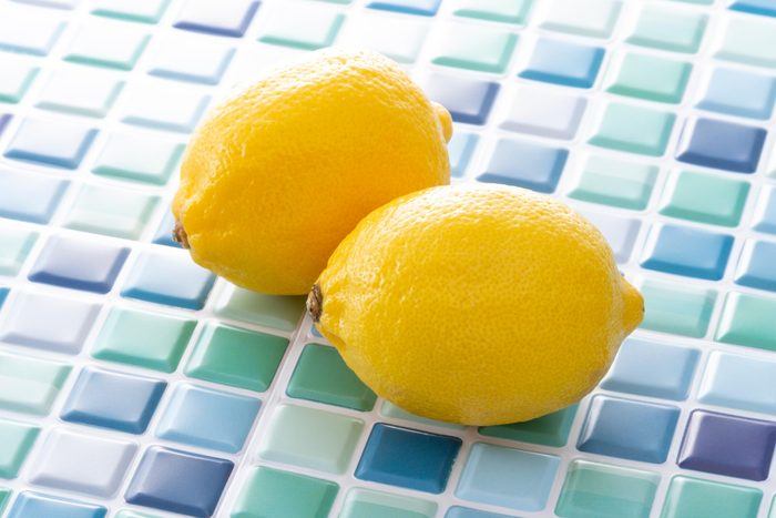 two Lemons on blue bathroom tiles background