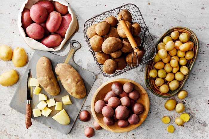 a variety of types of potatoes on a kitchen counter