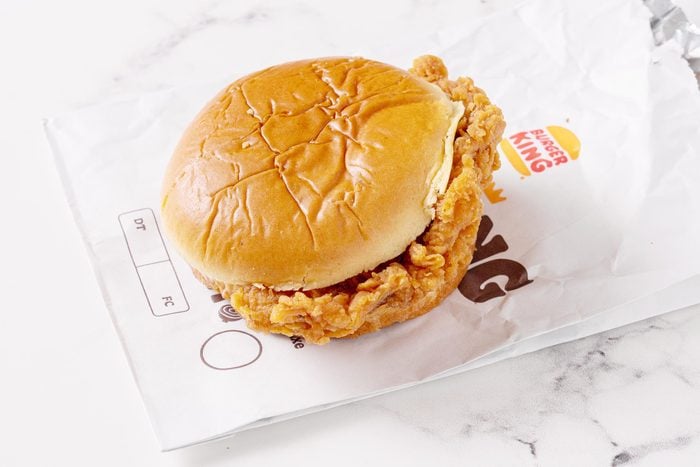 Burger King chicken sandwich with its packaging on a white kitchen counter