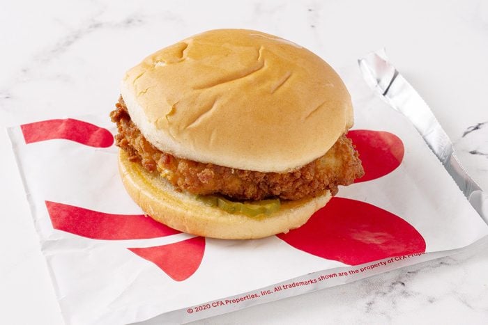 Chick Fil A chicken sandwich with its packaging on a white kitchen counter