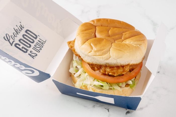 Culver's chicken sandwich with its packaging on a white kitchen counter