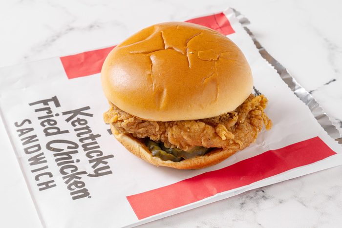 KFC chicken sandwich with its packaging on a white kitchen counter