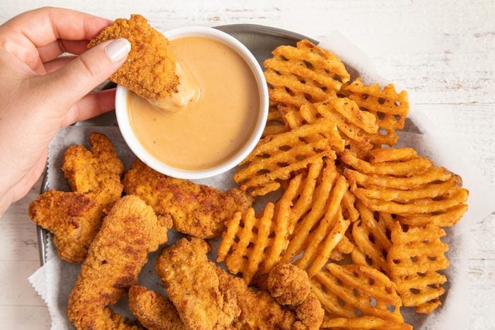 side of chick fil a sauce with waffle fries and chicken strips