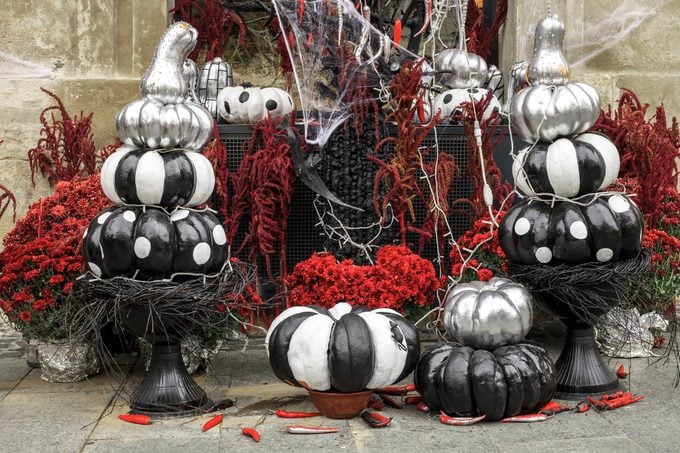 Painted pumpkins and red flowers, Halloween decorations