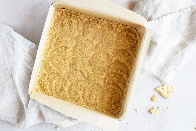 graham cracker crust in a square baking dish