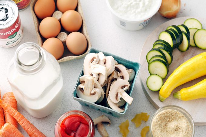 eggs, milk, mushrooms and zucchini on a kitchen counter ready for meal prepping