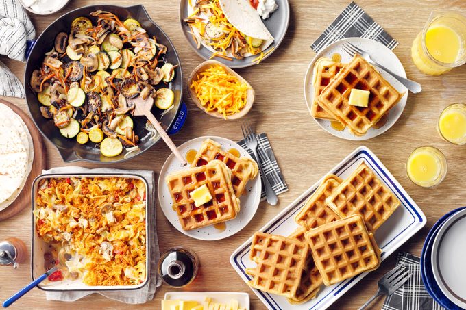 meal prep dishes on plates and baking pans including waffles, a 