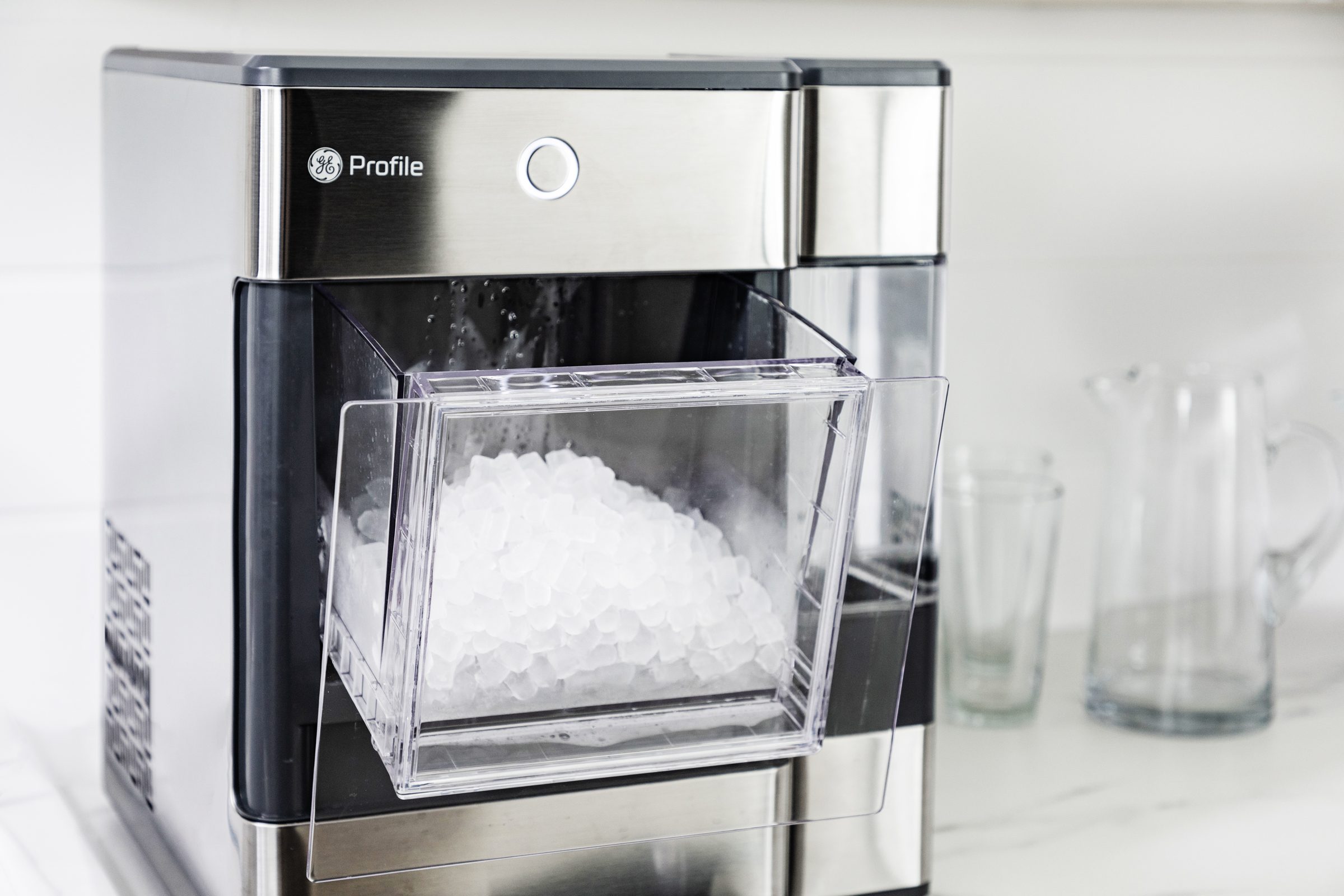 GE Profile Opal Nugget Ice Maker filled with ice on a kitchen counter