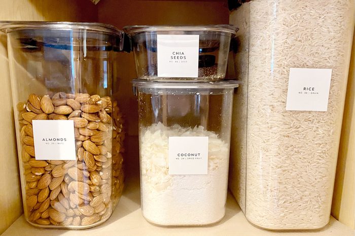 organized dry goods in a pantry using TikTok labels on reusable plastic storage containers